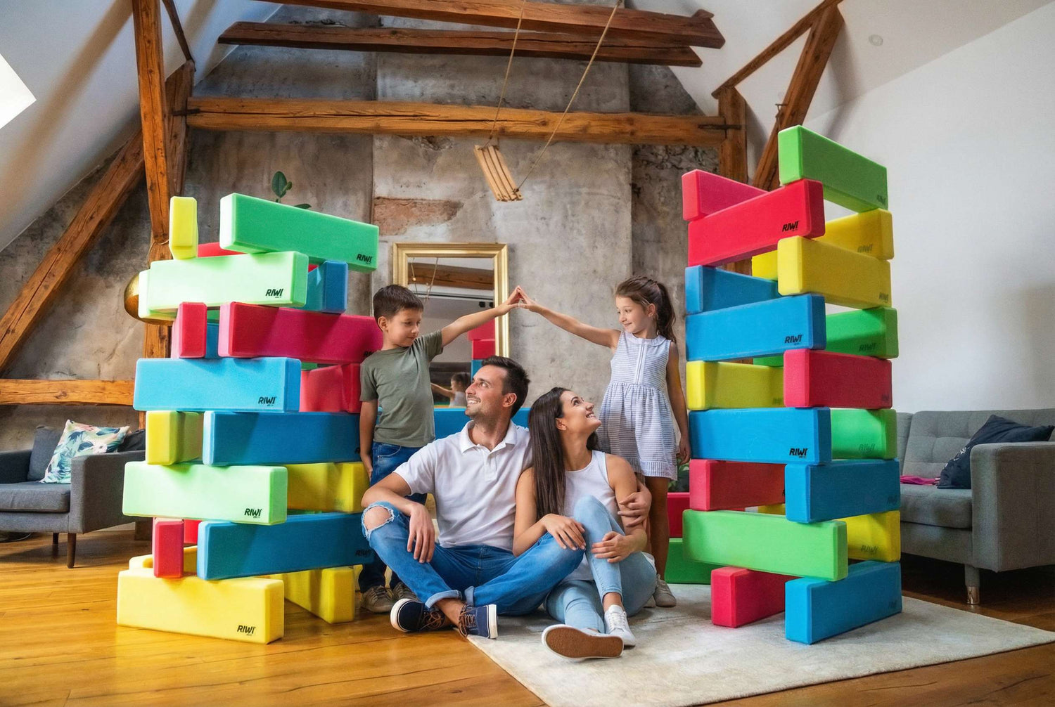Family playing with colorful RIWI building blocks in a living room