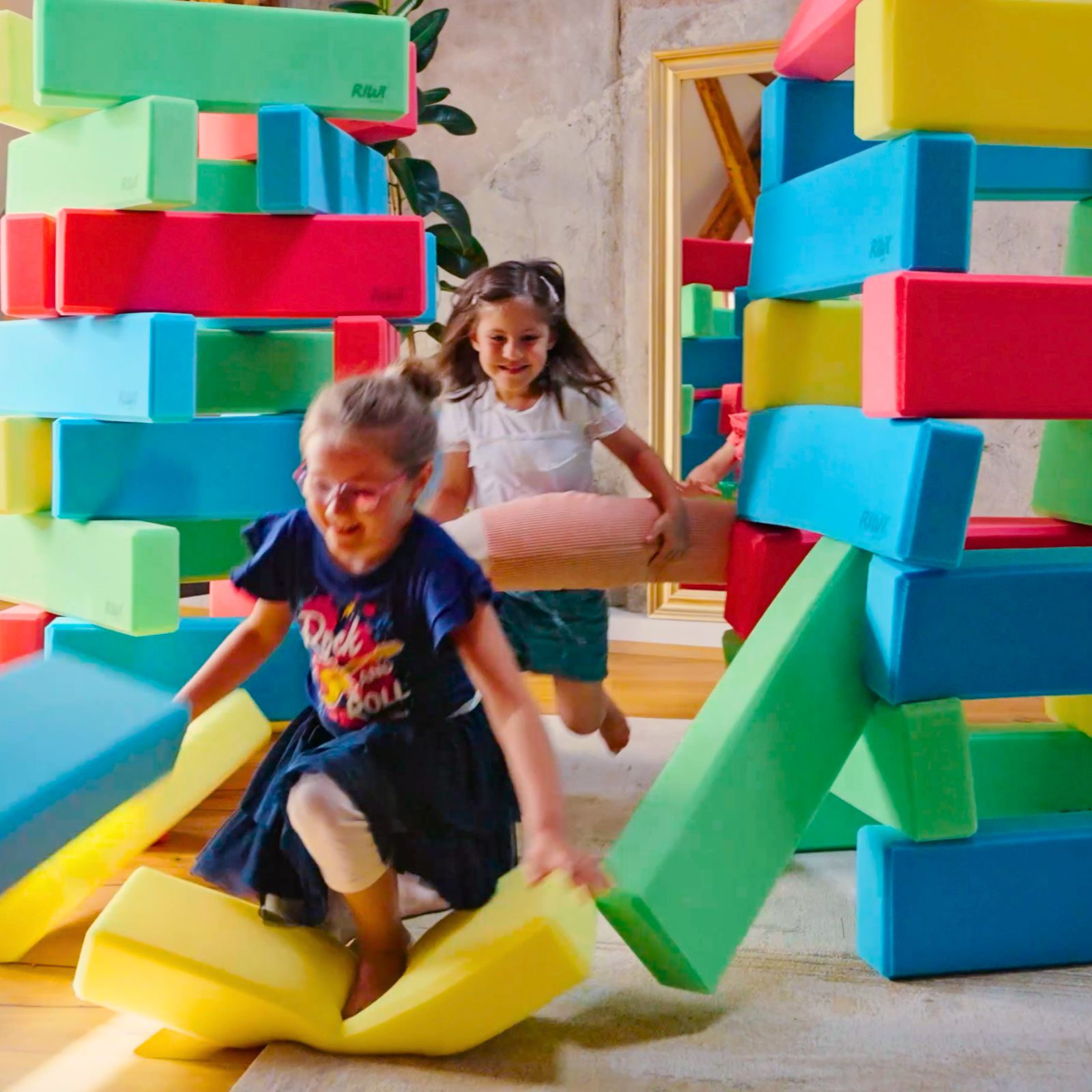 Children playing with colorful foam blocks indoors RIWI blocks
