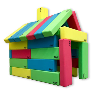 Colorful foam blocks stacked in a house shape on a white background RIWI blocks