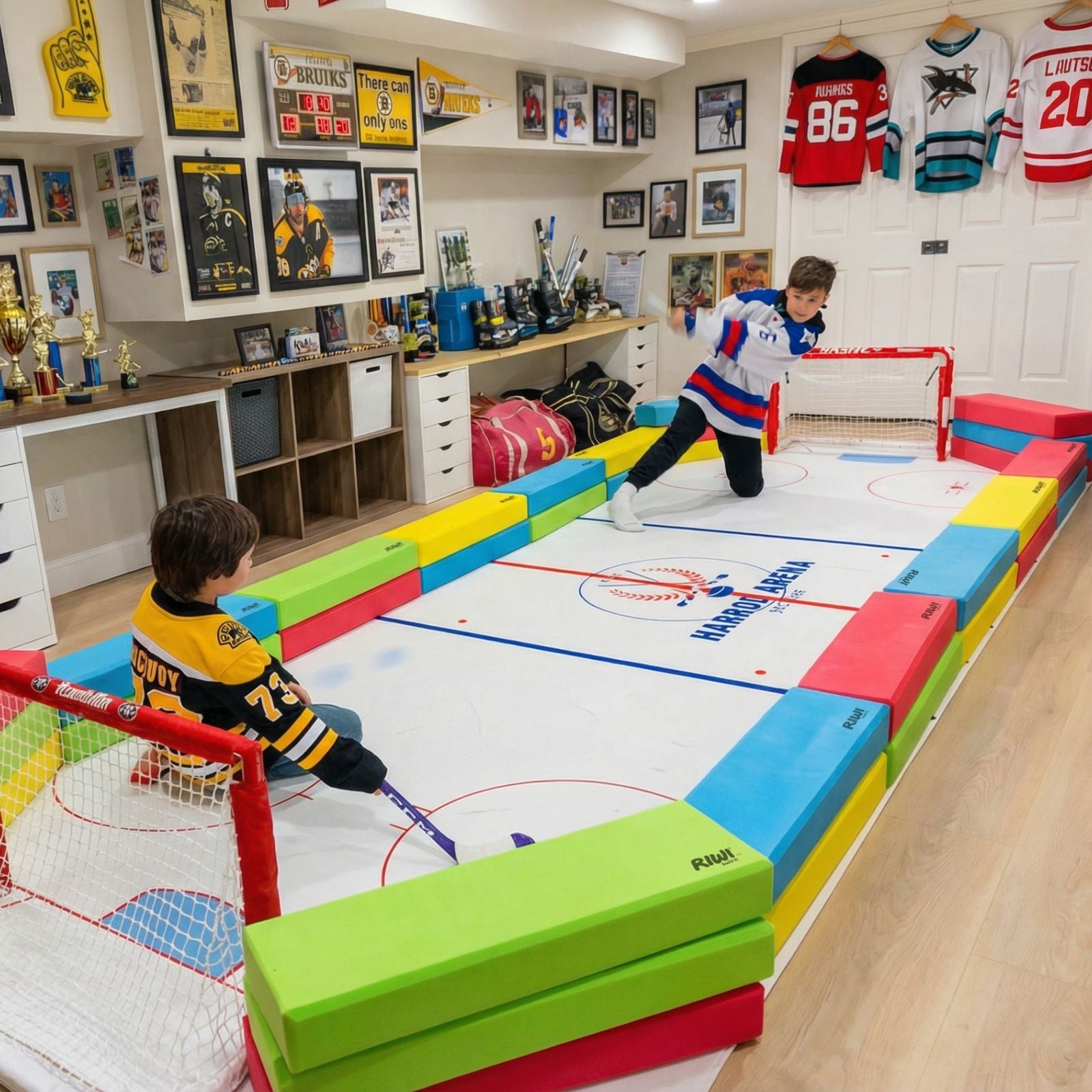 Children playing on a colorful indoor hockey rink with sports memorabilia on the walls. RIWI blocks